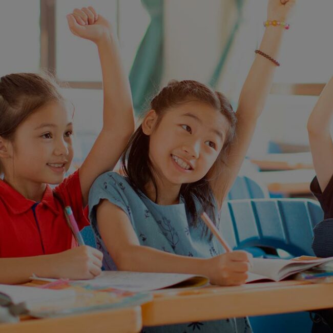 happy elementary school kids in classroom